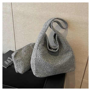 Detail view of the gray knitted wool hobo bag set including a matching mini pouch