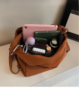 Interior view of brown bucket bag showing large capacity for tablets and daily items