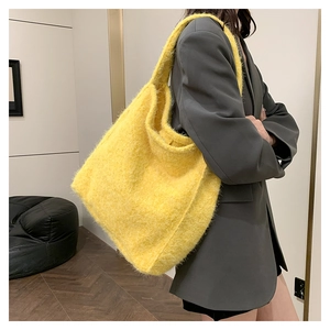 Detail of soft yellow faux mohair tote bag showing rich fuzzy texture and wide shoulder strap