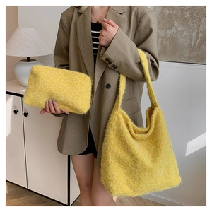 Detail view of fuzzy yellow mohair tote bag and matching pouch on a fashion model