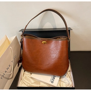 Retro brown leather handbag displayed with elegant gift box and packaging set