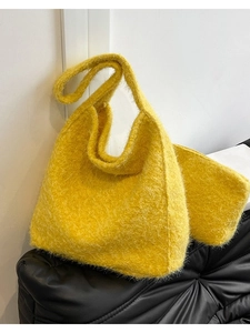 Bright yellow plush wool shoulder bag in a minimalist hobo style with soft texture