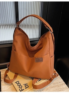 Caramel orange high-capacity canvas shoulder bag with dual-use straps for daily commute