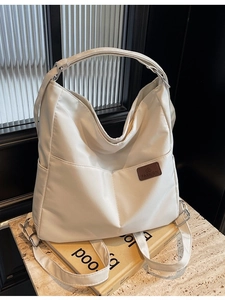White large capacity canvas shoulder bag with dual front pockets and fashion leather label