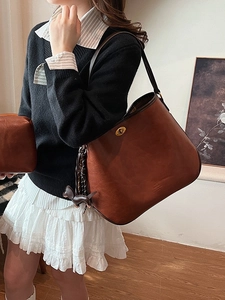 Retro brown leather shoulder bag with gold twist lock and cute dog bag charm