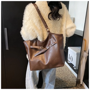 Detail of the litchi texture PU leather and gold buckle on this large tote bag