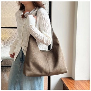 Detail shot of a large mocha brown suede hobo bag with vertical stitching for daily commute