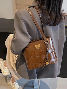 Bolso tote de cuero trenzado marrón con logotipo metálico y colgante de campana