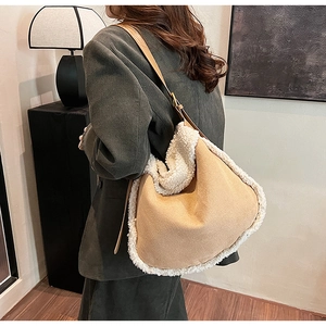 Detail of autumn suede crossbody bag with white shearling trim and adjustable leather strap
