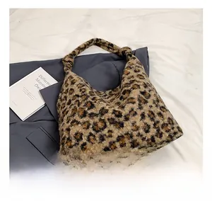 Close-up of fluffy faux fur leopard print tote bag texture and soft plush material