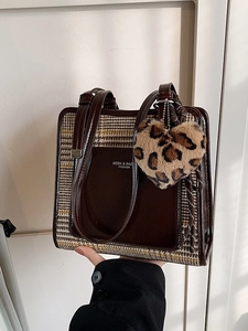 Brown houndstooth tote bag with gloss leather trim and leopard heart charm