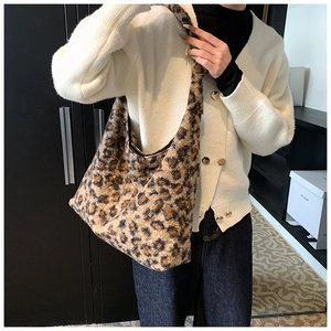 Detailed texture of plush leopard print hobo bag with zip closure and wide shoulder strap