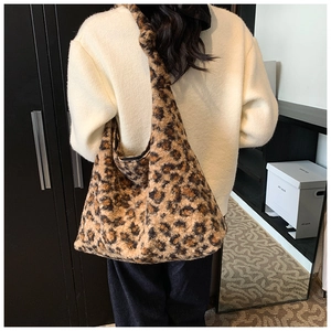 Detail showing the large leopard print hobo tote bag with plush faux fur texture and knot strap