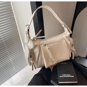 Détail du sac bandoulière en cuir PU crème avec design multi-poches et cordons de fermeture éclair