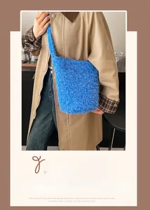 Detail of royal blue plush bucket bag with wide shoulder strap worn by a model