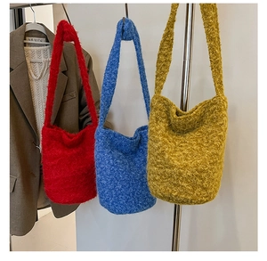 Detailed texture of colorful soft knit shoulder bags in red, blue, and yellow finishes