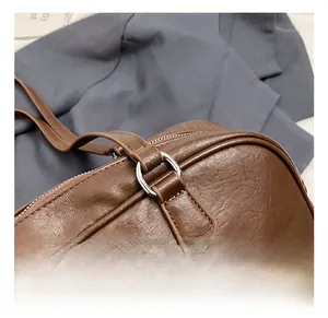 Detailed macro view of silver metal ring hardware on brown leather bowling bag