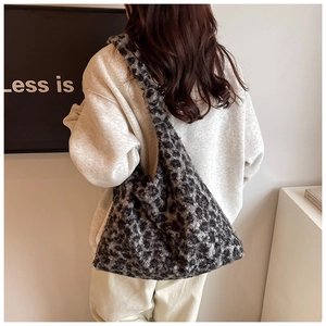 Detailed view of plush leopard print tote bag texture and soft faux fur material