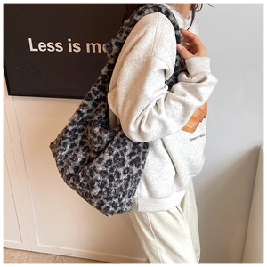 Close-up of leopard print plush tote bag showing soft faux fur texture and large capacity