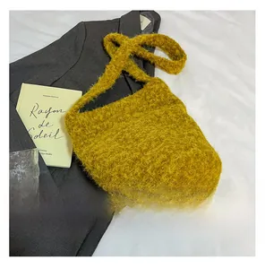 Ginger yellow plush shoulder bag styled on a grey blazer with artistic props