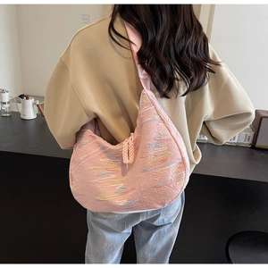 Pink crescent shoulder bag with colorful wave embroidery and wide strap detail