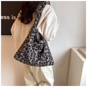 Detail of grey leopard print plush tote bag with thick texture and wide shoulder strap
