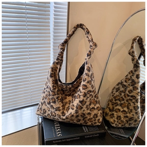 Detail of soft leopard print plush hobo bag with a unique knotted strap design