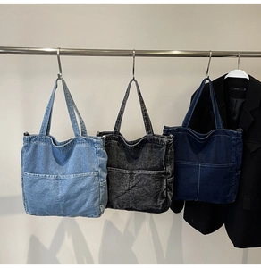 Three shades of denim tote bags in light blue, smokey grey, and dark indigo colors