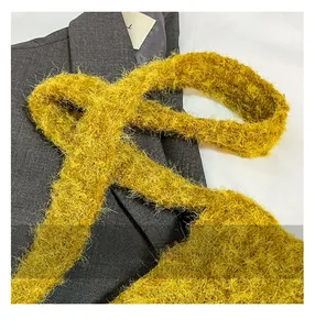 Macro shot of ginger yellow faux fur fabric texture against a dark grey suit