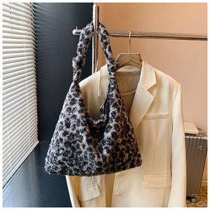 Detail of soft leopard print plush tote bag showing the fuzzy faux fur texture on a hanger