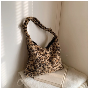 Detail of leopard print hobo bag showing faux fur texture and knotted strap detail