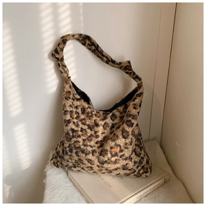Macro view showing the soft leopard print texture and plush fabric of the large tote bag