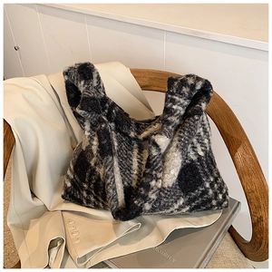 Detail showing the plush faux fur texture and black-white checkered pattern of the tote bag