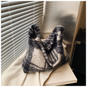 Detailed texture of grey and white checkered wool tote bag with a soft woven finish