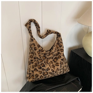 Detail of the soft faux fur leopard print tote bag against a minimalist studio background