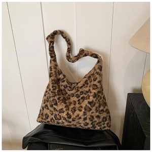 Close-up of leopard print tote bag showing soft faux fur texture and knotted strap detail