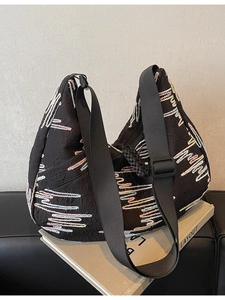 Black crescent hobo bag with colorful wave embroidery and adjustable wide shoulder strap