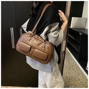 Detailed side view of a brown vintage PU leather shoulder bag with double front flap pockets
