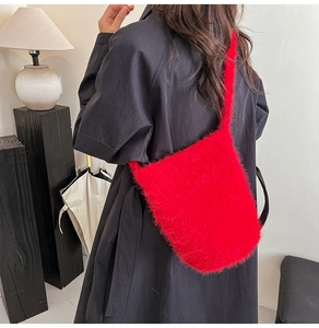 Red plush bucket bag back view on model with fluffy shoulder strap for autumn and winter