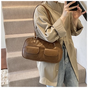 Brown retro PU leather shoulder bag with double front flap pockets in casual urban setting