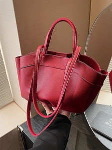 Red pebbled leather tote bag with white stitching details and detachable shoulder strap