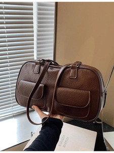 Retro dark brown textured leather handbag with dual front pockets and shoulder strap