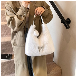 White fluffy faux fur tote bag featuring a silver butterfly buckle and soft plush texture