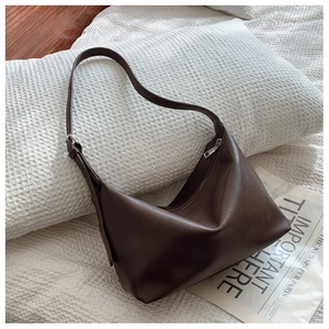 Detailed view of dark brown faux leather hobo bag with adjustable silver buckle strap
