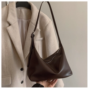 Detail of dark brown matte leather hobo bag with adjustable strap and silver zipper