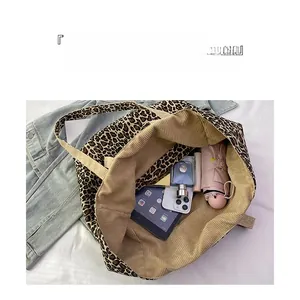 Detailed top view of a leopard print tote bag showing large capacity with daily essentials