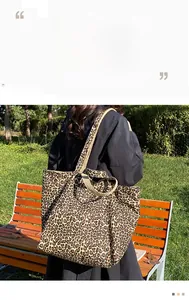 Outdoor view of a spacious leopard print tote bag featuring durable wide shoulder straps
