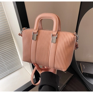 Detail of pink pleated tote bag with silver hardware and detachable shoulder strap