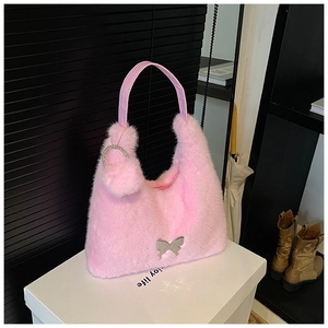 Close-up of pink faux fur handbag featuring silver butterfly buckle and horseshoe charm