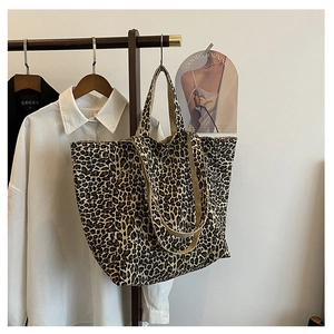 Detailed macro view of the leopard print canvas tote bag with thick shoulder straps